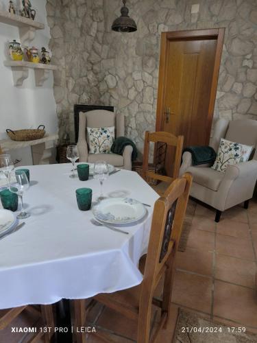 a dining room with a white table and chairs at Casa do Limoeiro - Casa in Golegã
