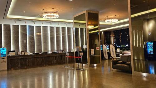 a lobby with a bar in a building at SainTree Hotel in Incheon
