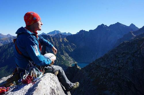 a man sitting on the top of a mountain at Tatra Góral Ski Apartament in Murzasichle