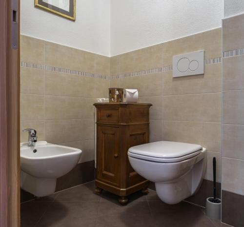 a bathroom with a toilet and a sink at Casa Beba in Bormio