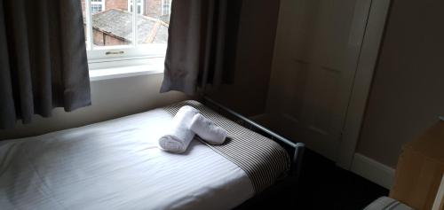 a pair of socks sitting on a bed next to a window at The Grapes in Southampton