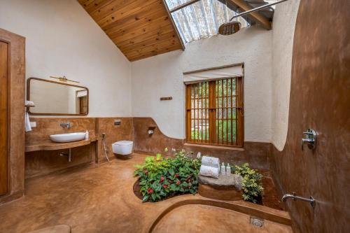 a large bathroom with a sink and a mirror at SaffronStays Rustic Trails in Mulshi
