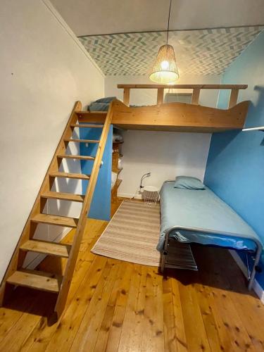 a bunk bed in a room with a staircase at L'échappée Jurassienne - Tout équipé au calme in Saint-Claude