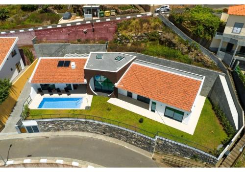 an aerial view of a house with a swimming pool at The pool house in Ponta de Sol in Funchal
