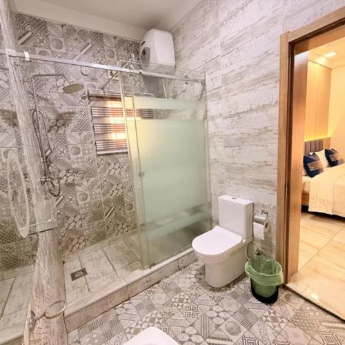 a bathroom with a shower and a toilet in it at Star Wish Business Hotel in Lagos