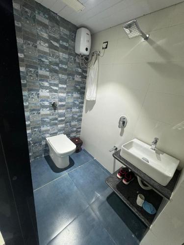 a bathroom with a sink and a toilet at The BVM Hostel in Mumbai