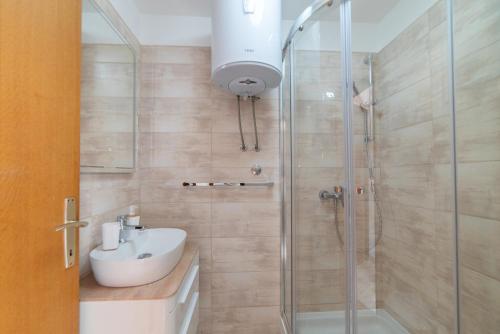 a bathroom with a sink and a shower at Nikola apartment in Božava