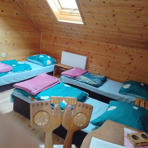 a room with three beds in a cabin at Baza Warsztatowo-Edukacyjna K85 Komańcza in Komańcza