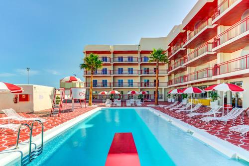 a swimming pool with chairs and a hotel at Romeos Ibiza - Adults Only in San Antonio Bay