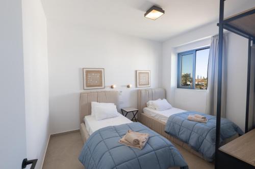 a room with two beds and a window at Orea Luxury Villas in Ayia Napa