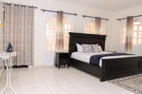 a bedroom with a large bed and windows at Zaya Luxe Home in Naivasha