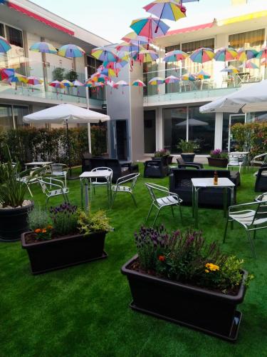 a courtyard with tables and chairs and umbrellas at Welcome In in Aveiro