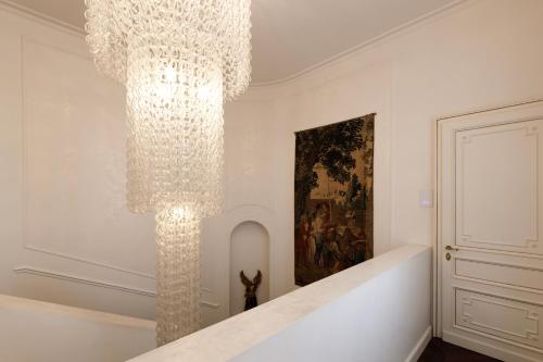 a large chandelier hanging from a wall in a room at Relais Metelli in Foligno