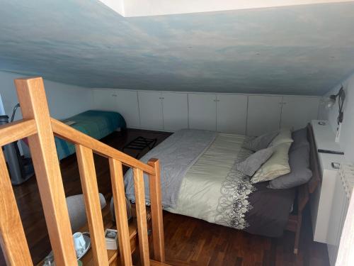 a bedroom with a bed in a small room at B&B Menta e Rosmarino in Chiassa Superiore