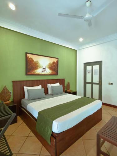 a bedroom with a large bed in a room at The Villa Green Inn in Negombo