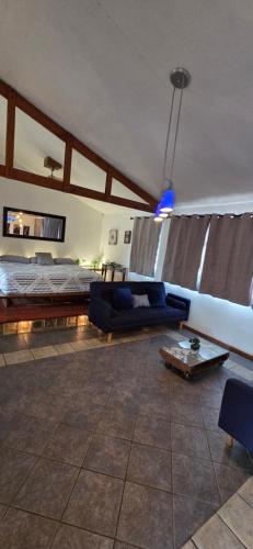 a living room with a bed and a couch at Private Apt, AC, Jacuzzi, parking Centro in Escuintla
