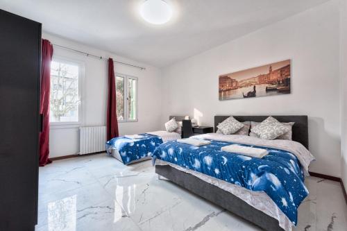 a bedroom with two beds and a window at Cesare Room in Apartment in Marghera