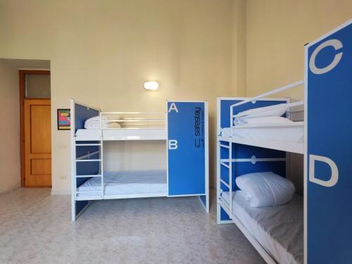 a room with two bunk beds in a room at Safestay Naples Materdei in Naples