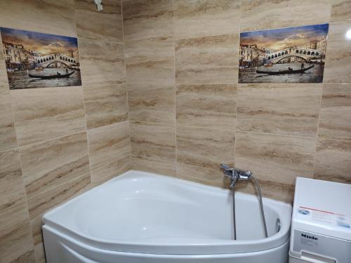 a bathroom with a toilet and a bath tub at Apartament Maya luxury in Bucharest