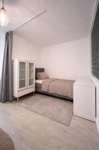 a bedroom with a bed and a dresser in it at Casaejon in Lelystad