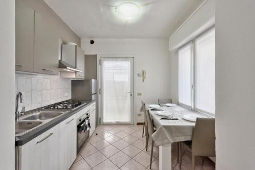 a kitchen with a sink and a stove top oven at Marila 5, a due Passi dal Mare in Lido di Jesolo