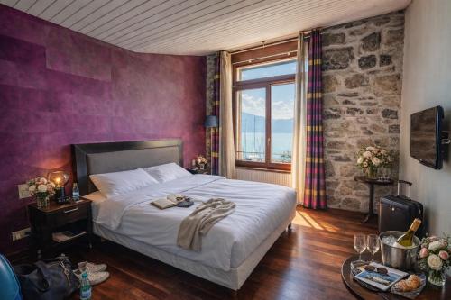 a bedroom with a large bed and a window at Rivage Hotel Restaurant Lutry in Lausanne