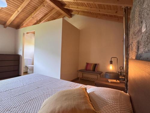 a bedroom with a bed and a couch in a room at Serena Nest 03 in Rio Douro