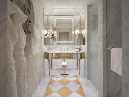 a bathroom with a sink and a large mirror at Danieli, Venezia, A Four Seasons Hotel in Venice