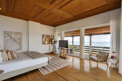 a bedroom with a bed and a view of the ocean at Blissful Seafront in Cascais