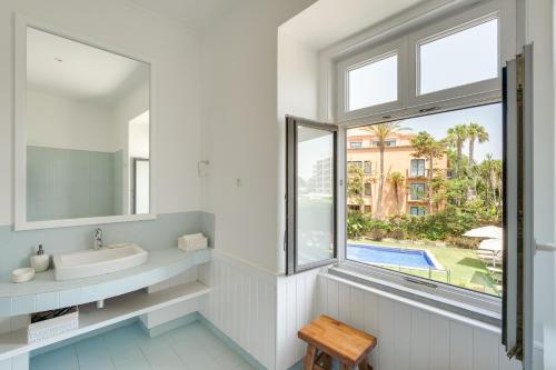 a bathroom with a sink and a window at Blissful Seafront in Cascais