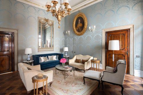 a living room with a couch and a chandelier at Danieli, Venezia, A Four Seasons Hotel in Venice