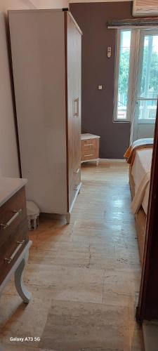 a bedroom with a bed and a dresser and window at Haluk Otel in Oren