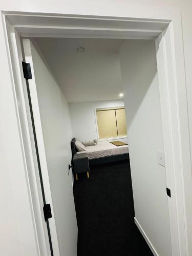 a small room with a bed in the ceiling at TheQuietPadRest Easy Fly Easy in Christchurch