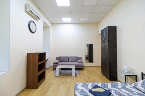 a living room with a purple couch and a chair at Hostel in the center in Kyiv
