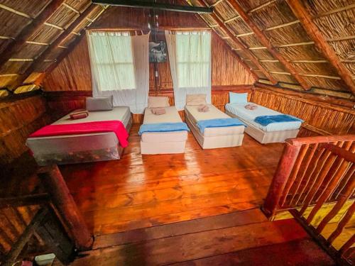 an overhead view of a room with three beds at Zambeze Lodge in Marracuene
