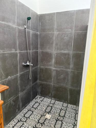 a bathroom with a shower with a tiled floor at Villa Bella Vista in Hell-Ville