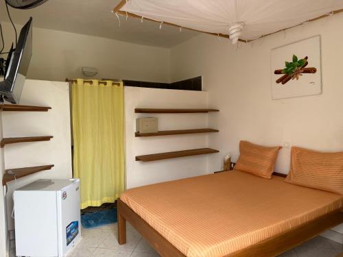 a bedroom with a bed and a yellow curtain at Villa Bella Vista in Hell-Ville