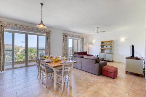 a living room with a table and a couch at Ta Frenc Apartments in Għasri