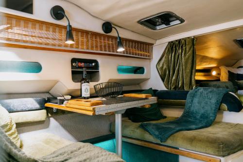 a living room with a table in a trailer at SLEEPBOAT YACHT in Oporto Douro in Porto