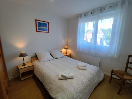 a bedroom with a bed with two towels on it at Yvéro in Quend-Plage