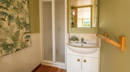 a bathroom with a sink and a mirror at Camping Derby Loredo by Mola! in Loredo
