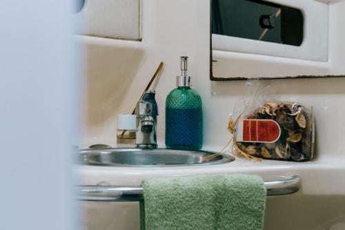 a bathroom counter with a sink and a mirror at SLEEPBOAT YACHT in Oporto Douro in Porto