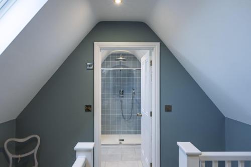 a bathroom with a shower in a attic at Appletree House in Sway