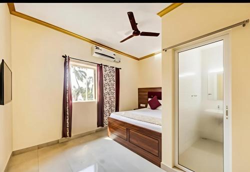 a bedroom with a bed and a mirror at SAI GUEST house in Calangute
