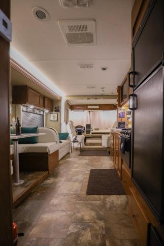 a kitchen and a living room in an rv at Kamper 30m2 max 4 osoby in Ciężkowice