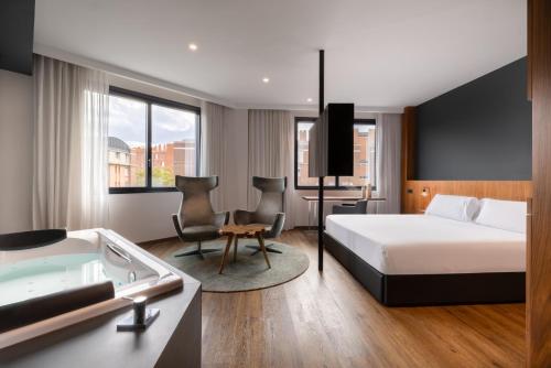 a hotel room with a bed and a bath tub at Hotel SB Icaria in Barcelona