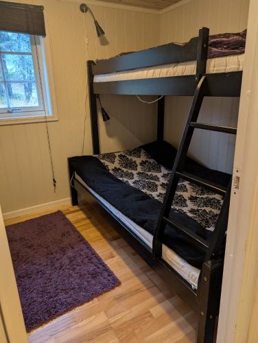 a bedroom with two bunk beds and a rug at Feriehjemmet in Ringsaker