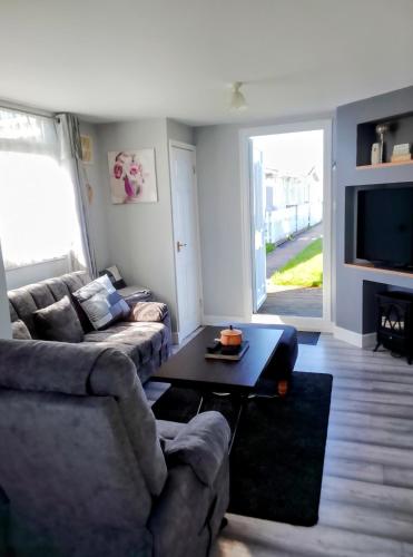a living room with a couch and a table at The Marylyn in Mablethorpe