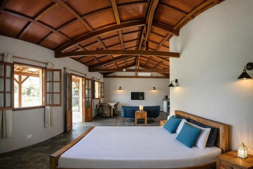 a bedroom with a bed and a living room at Coconut Lodge Open-Plan Suite with Kitchen, Indoor & Outdoor Showers & Infinity Pool in Cap Malheureux