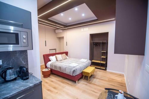 a small room with a bed and a tv at Assarotti Luxury Suite in Genoa